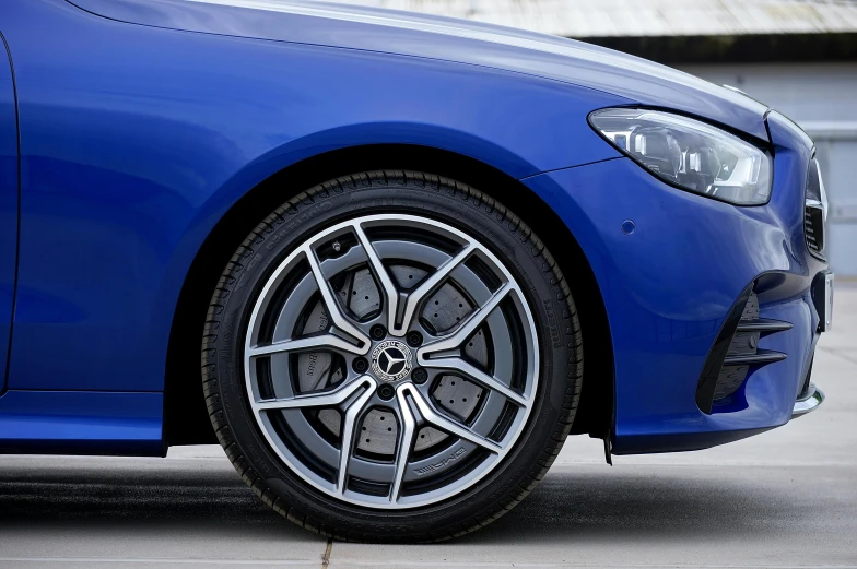 a blue car is parked on a concrete floor