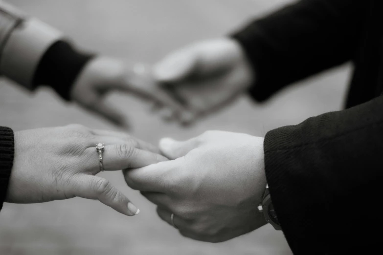 the couple is holding hands while they hold hands