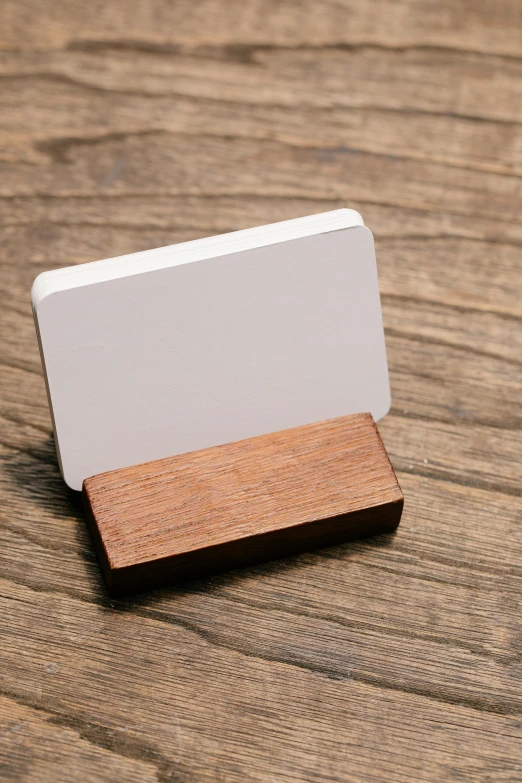 a wooden business card holder on top of a table