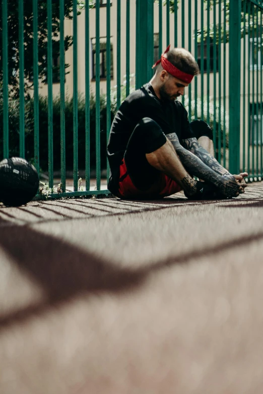 a man sitting on the sidewalk outside his home