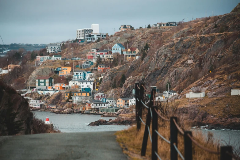 houses on a hill above a city by water