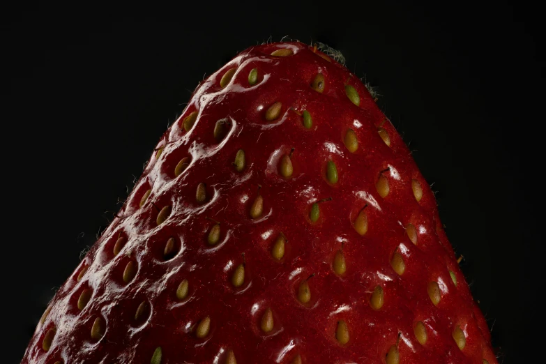 a red strawberry is pographed at night in the dark