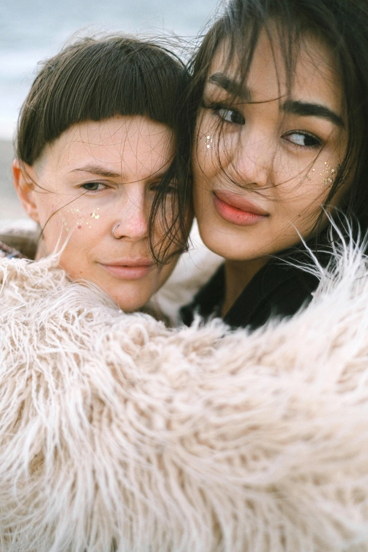 a woman is emcing another woman from behind her