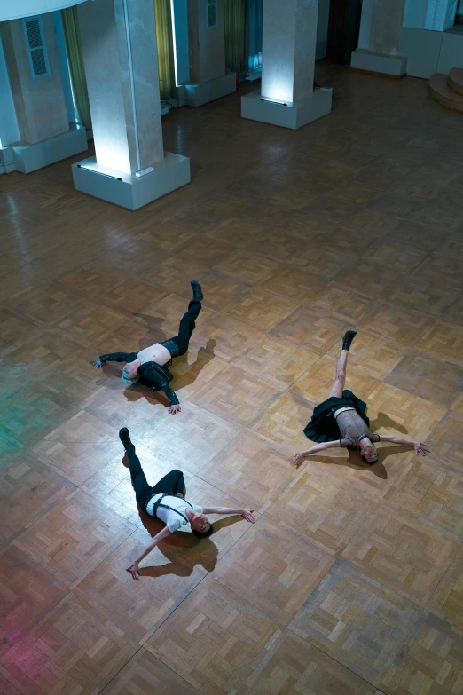 two people in black shirts and jeans on the floor