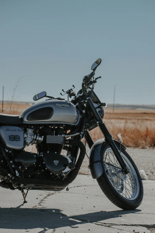 a motorcycle is parked in the cement on the road