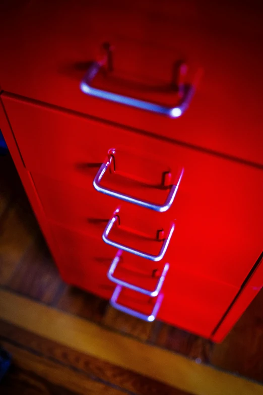 a red cabinet with some drawers on it