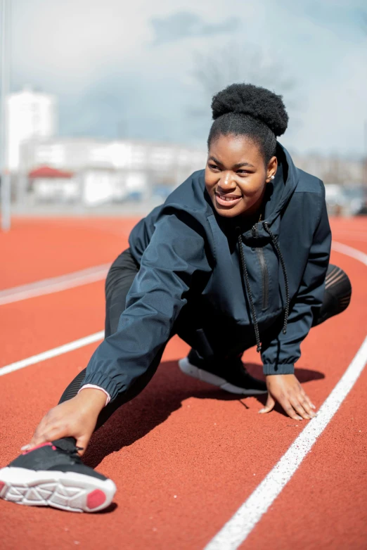 a woman crouches and smiles for the camera