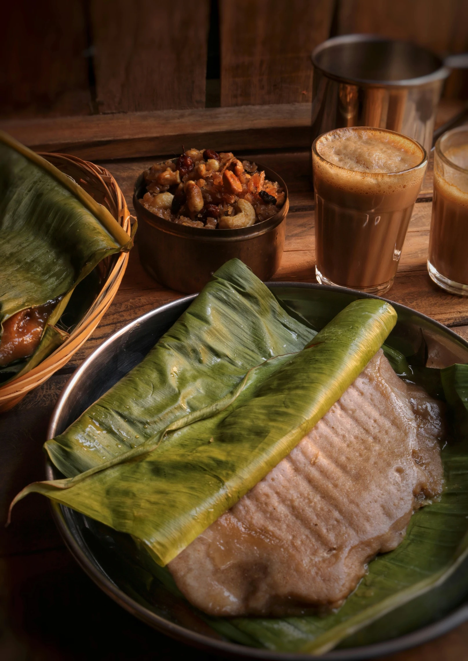 two large leaves sit on a plate with meat