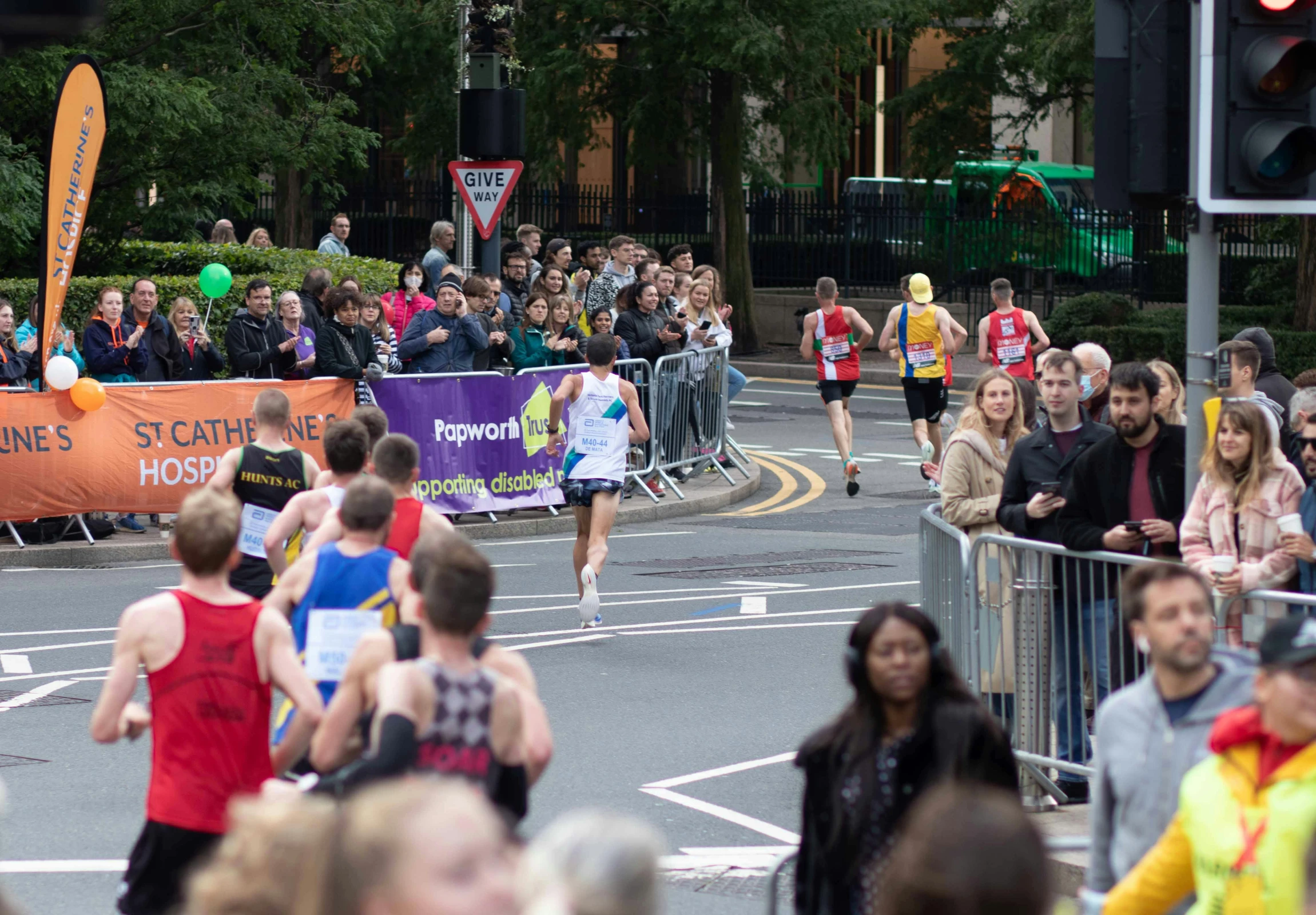 a group of people run a marathon in the city