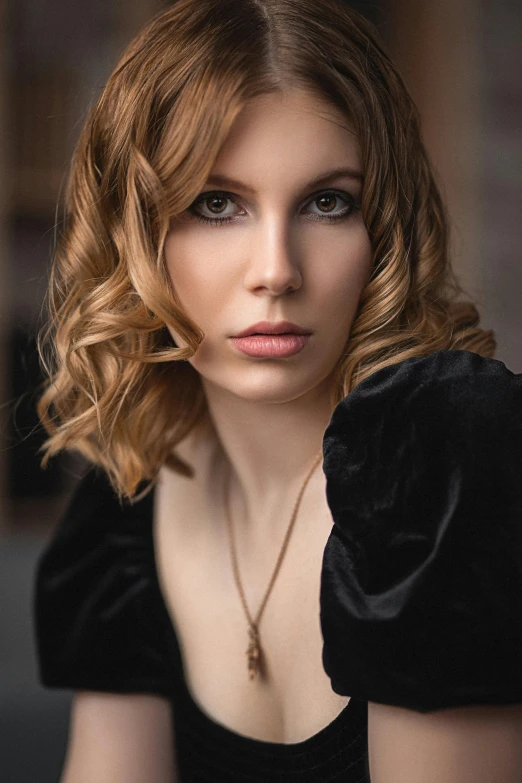 young woman with shoulder length wavy hair posing