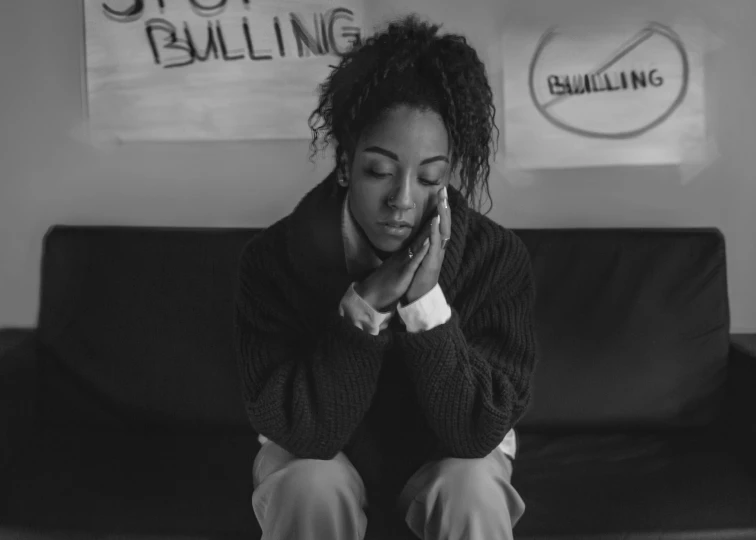 a woman sitting on top of a couch next to a wall