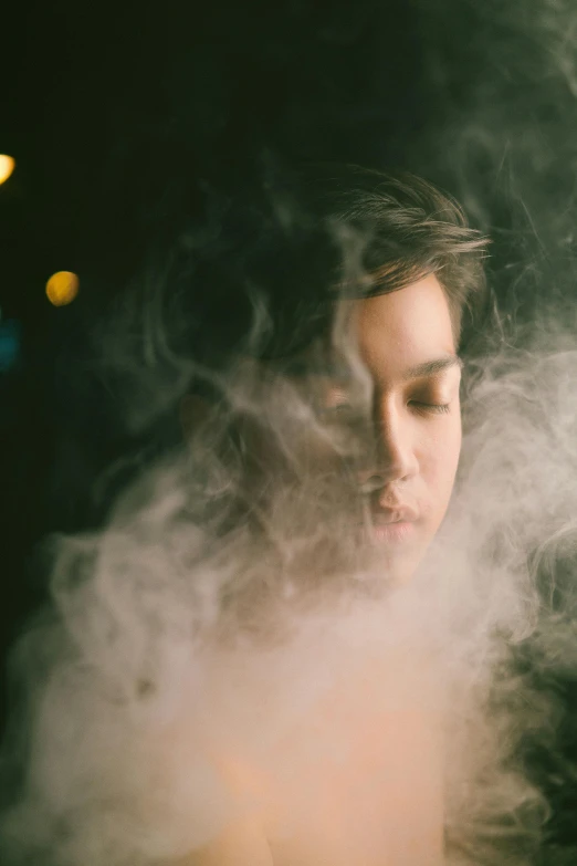 a woman in smoke with the light on