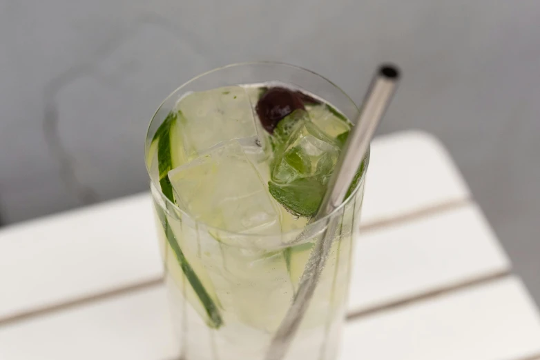 a clear glass with some green and purple drinks in it