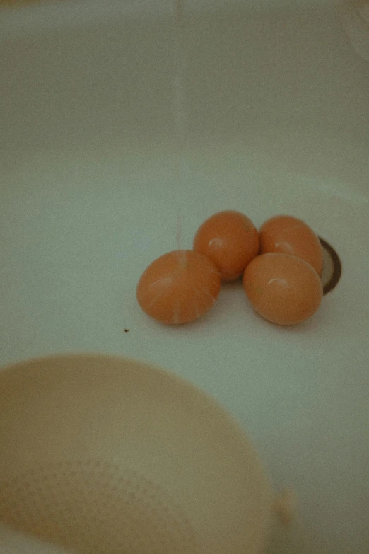 a closeup of some peeled carrots in a sink