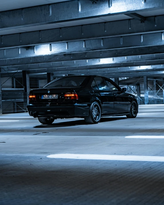 an image of a black car in a parking garage