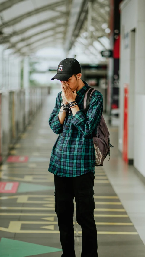 a person is standing in the hallway talking on a cell phone