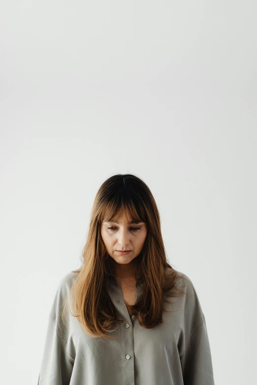 a woman standing in front of a white wall