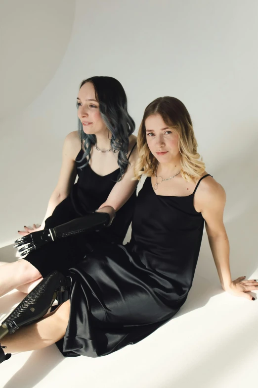 two young women dressed in black posing for the camera