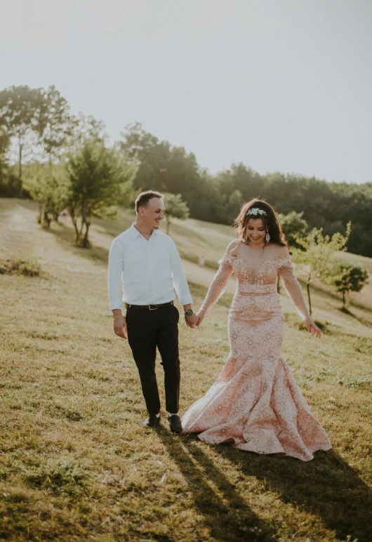 a bride and groom walk hand in hand holding hands