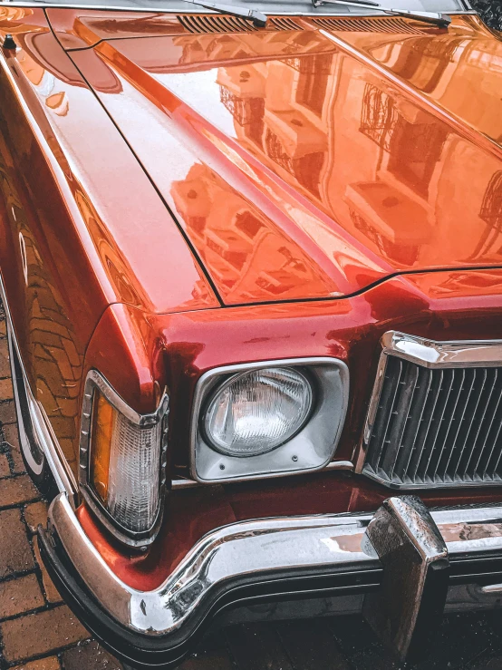 an orange automobile parked in a driveway near a house