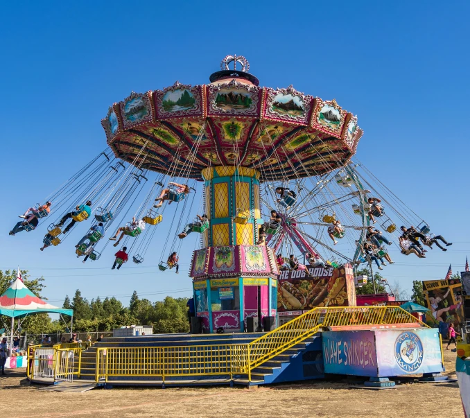an amut park is shown with multiple rides and swings