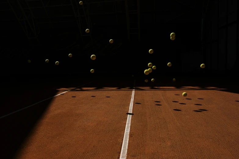 a tennis court is covered in balls during a game