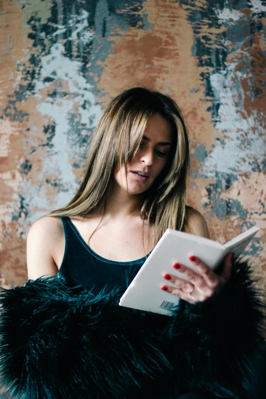 a women wearing a black top with a tablet