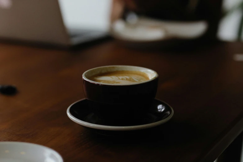 an espresso in a cup sitting on top of a saucer