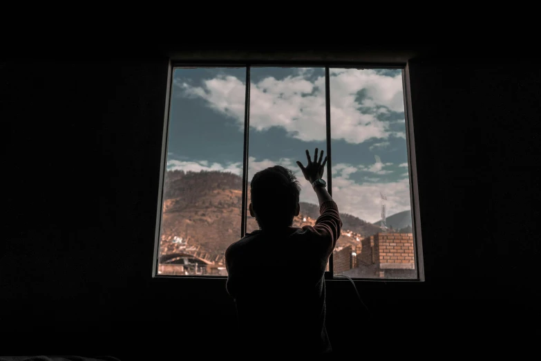 a person standing in front of a window with the sky visible