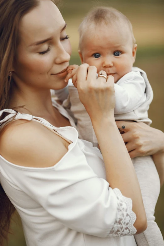 a mother and her baby girl outside in the fall