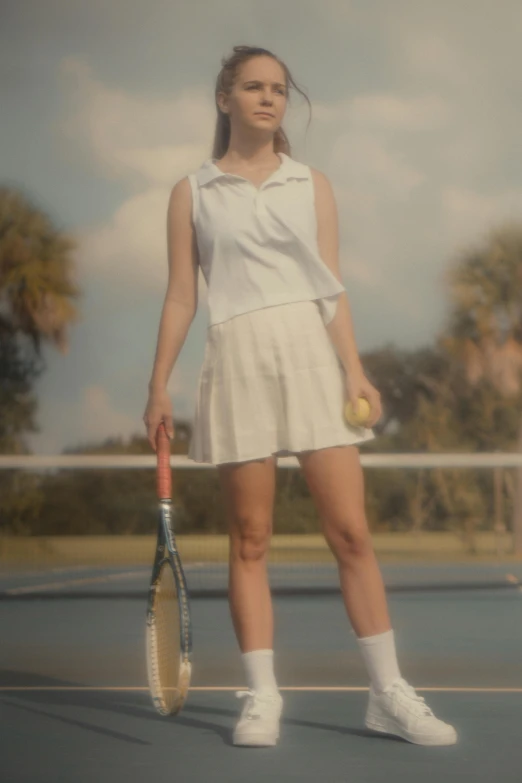 a girl is standing on a tennis court holding a racket