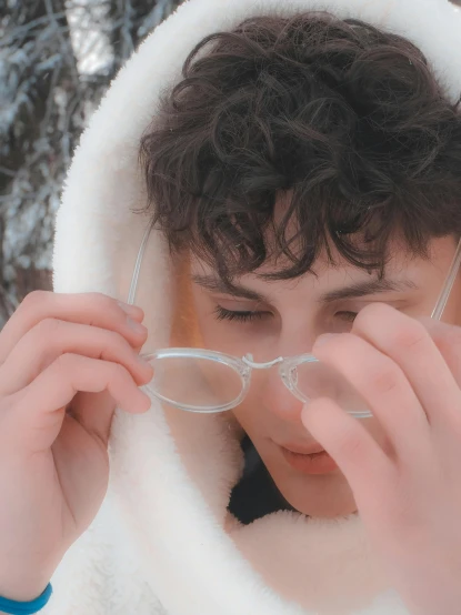 a boy wearing glasses while looking through some glass