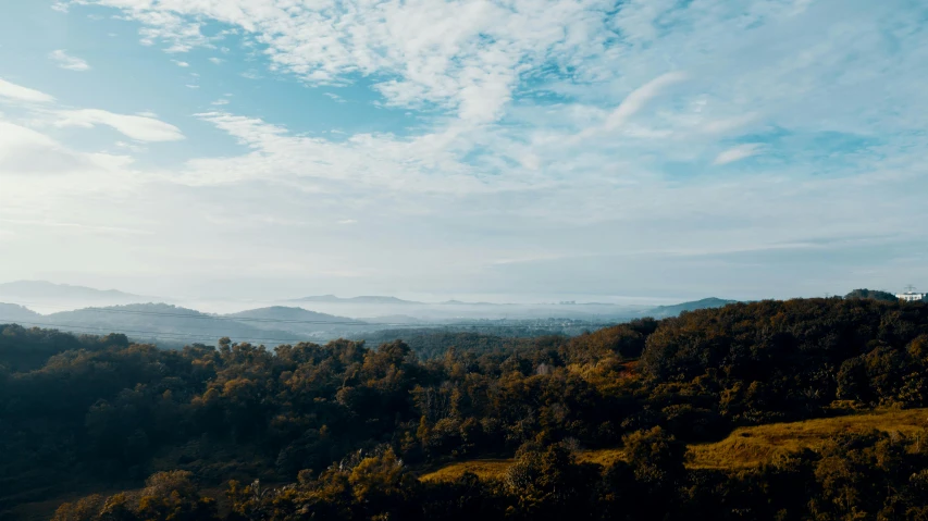 a view of the hills in the distance from a hill top