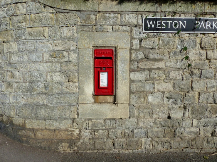 a wall with a brick wall and a sign on it