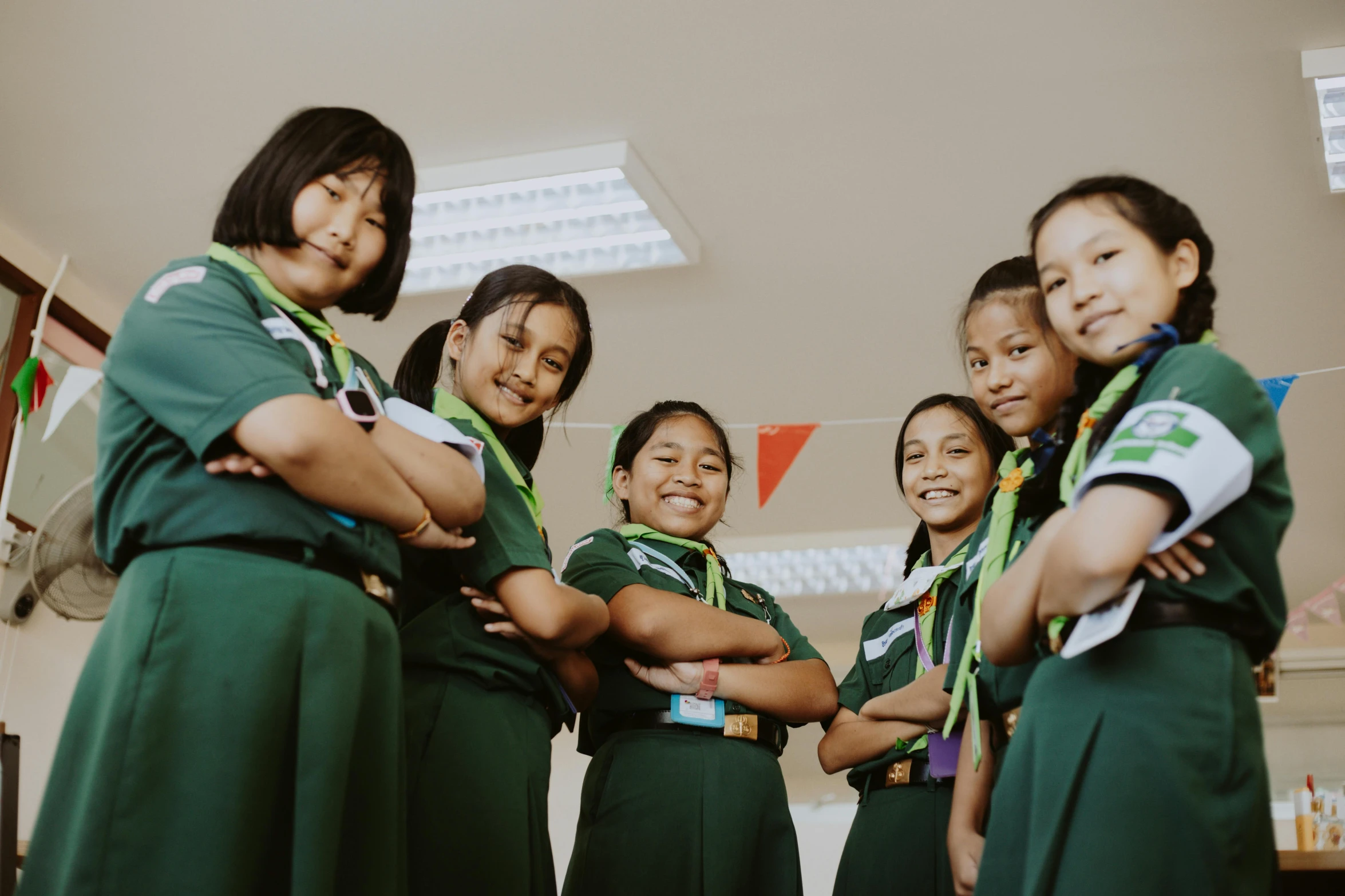 a group of women with green shirts standing next to each other