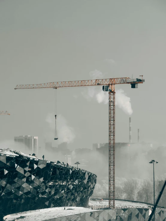 a building being built behind a construction crane