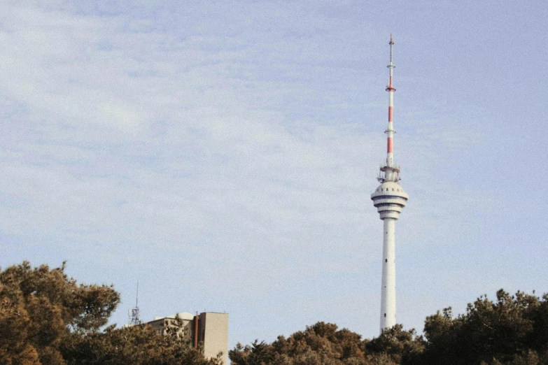 a very tall television tower towering over a city