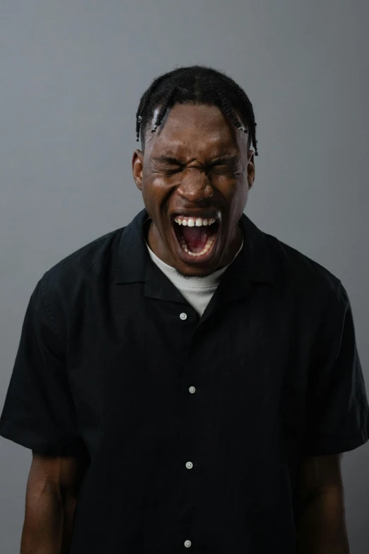 an african american man screaming over his eyes