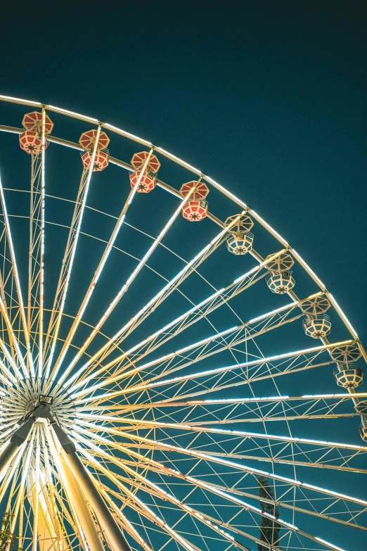 a ferris wheel with a dark blue sky behind it