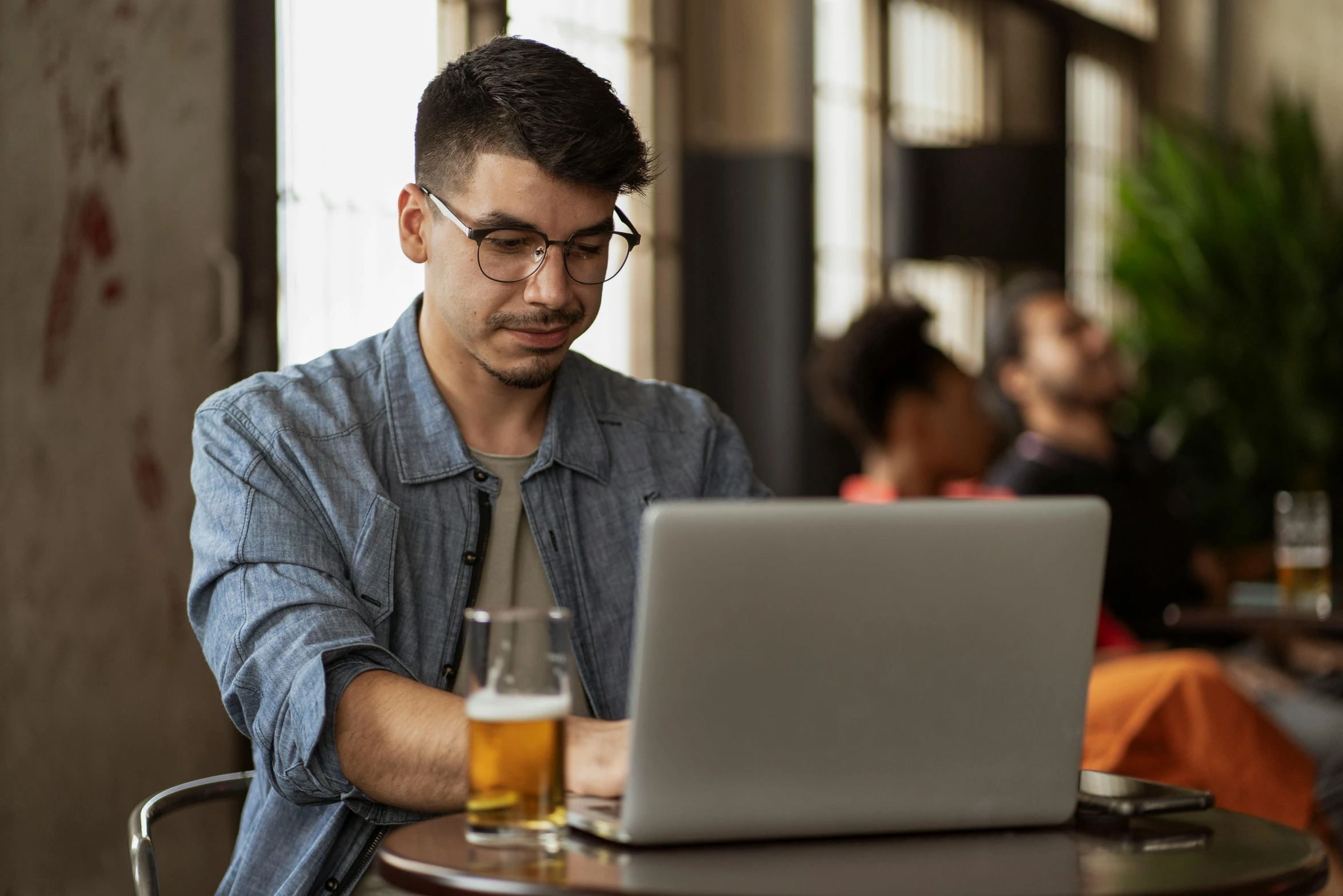 a man sitting in front of a laptop computer