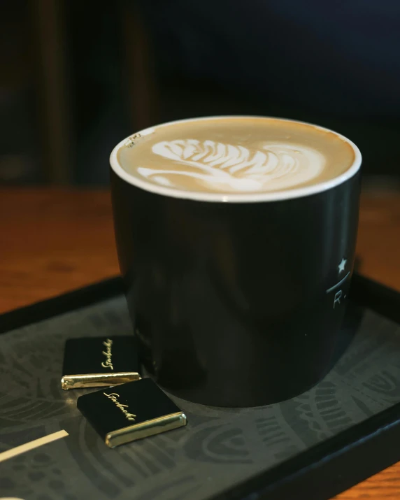 there is a latte art on the tray on the table