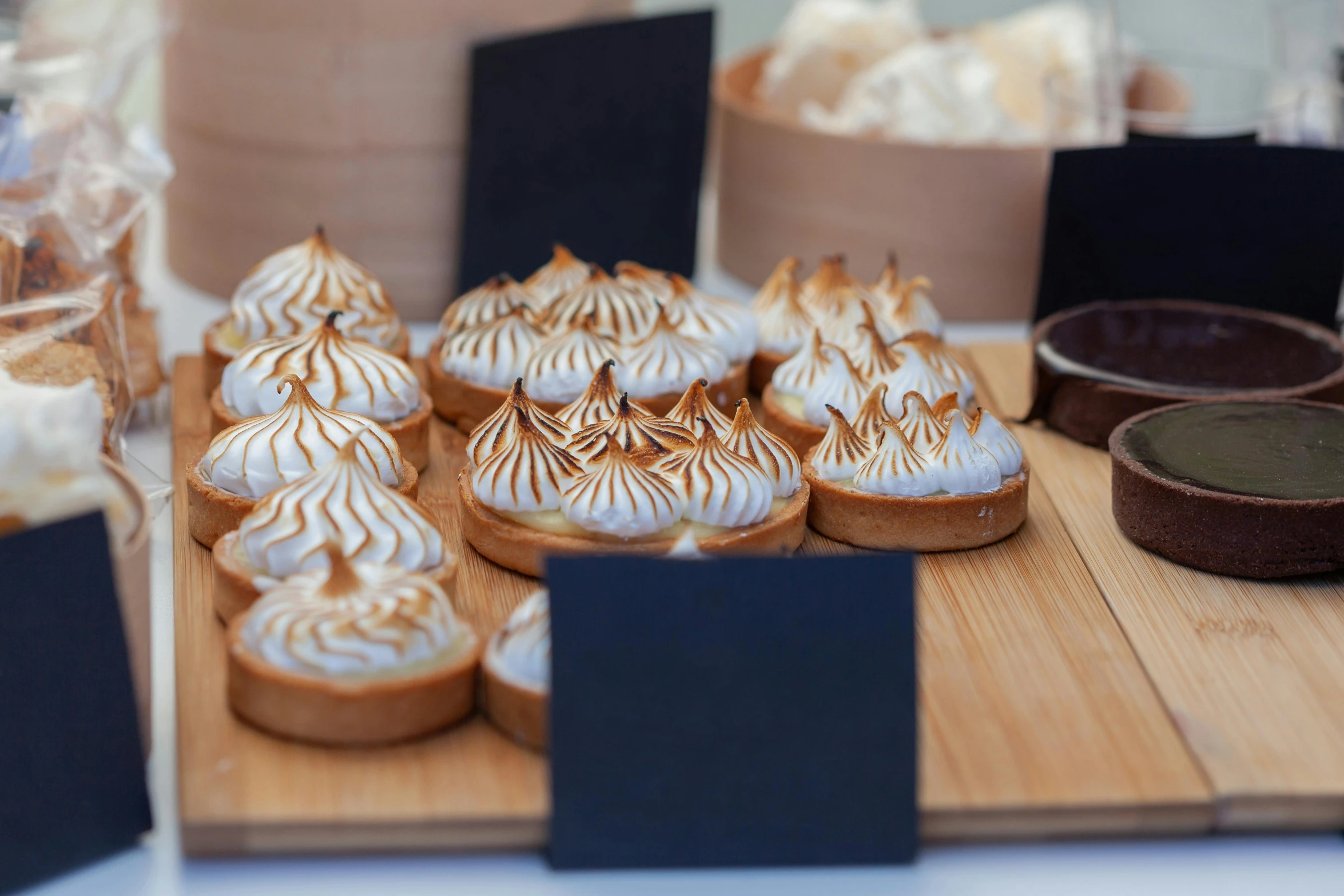 a table filled with various deserts covered in icing