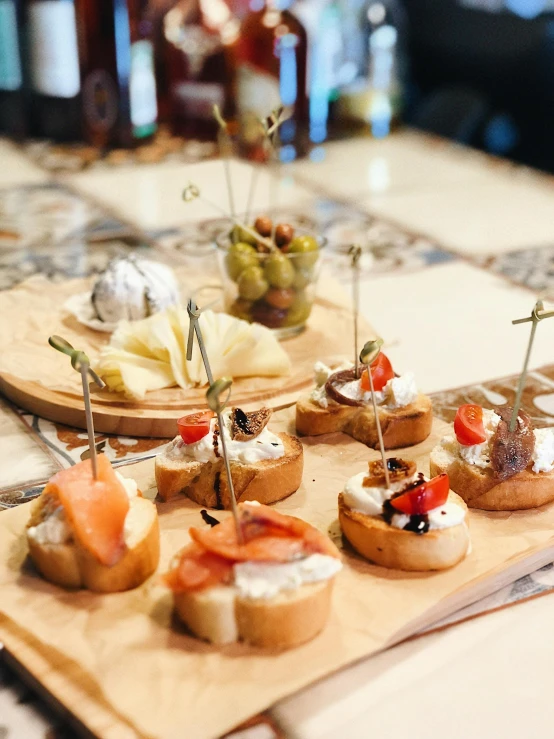 small appetizers served on wooden plates on tile table