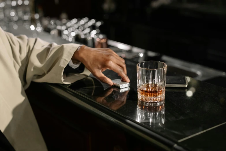 a bartender taps out a drink in the bar