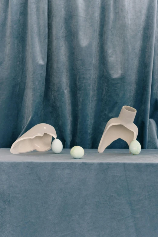 two sculpture pieces are sitting on the top of a table