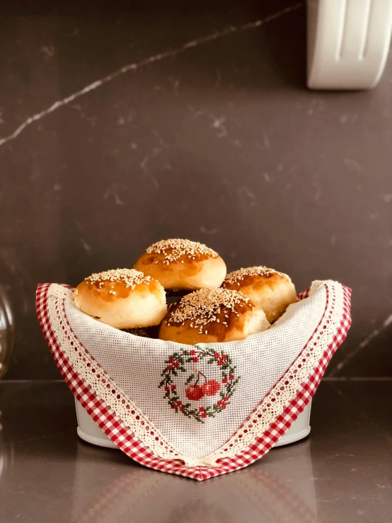 six bagels in a small basket on a table