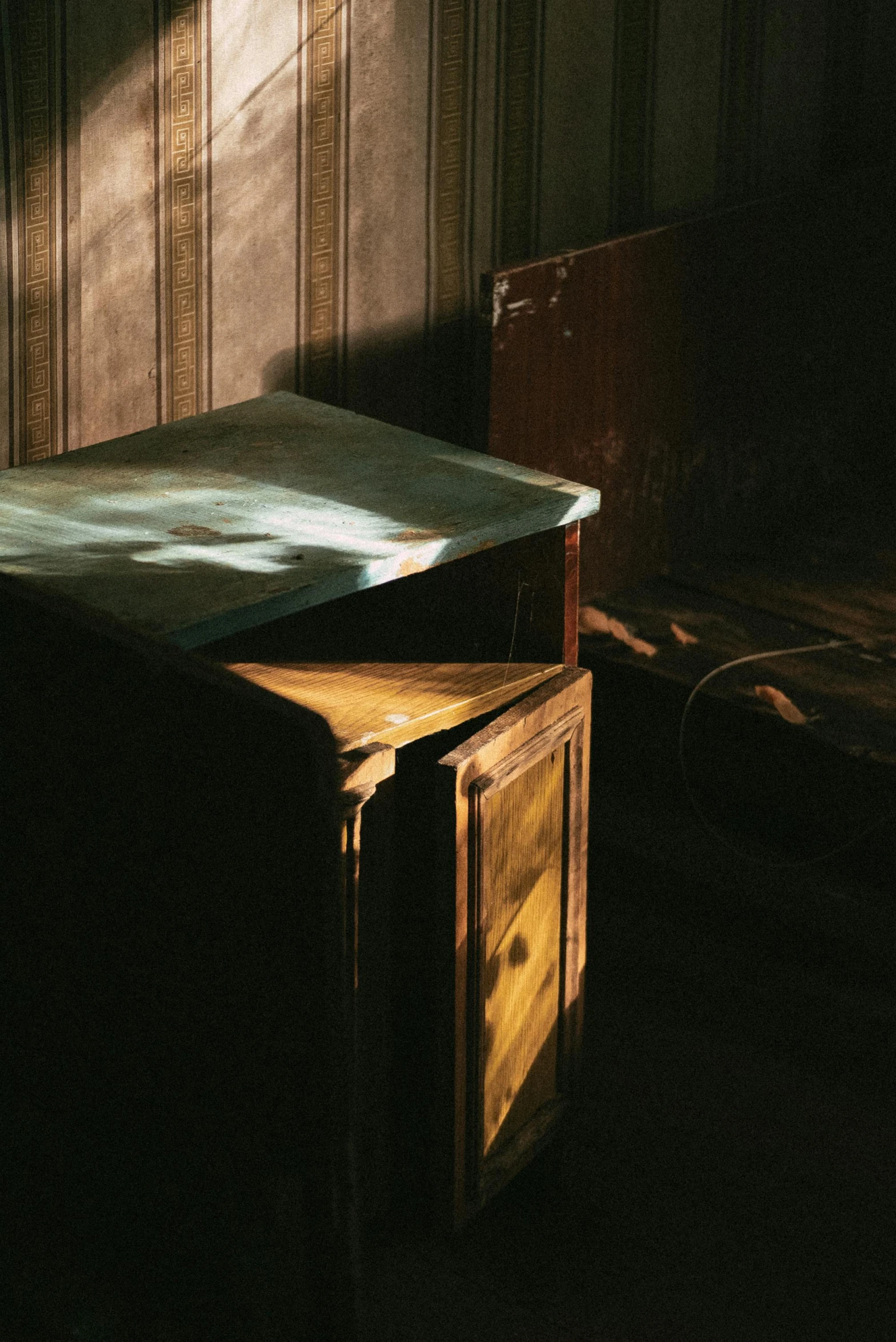 the shadow of a box and another object sit on a table