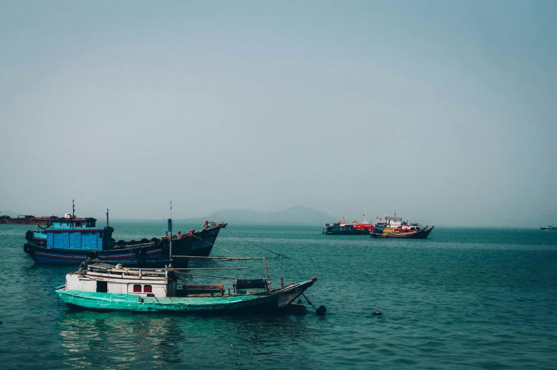 a group of boats floating in a body of water