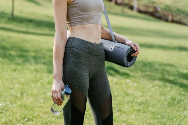the woman has no tank tops and is carrying an exercise gym bag