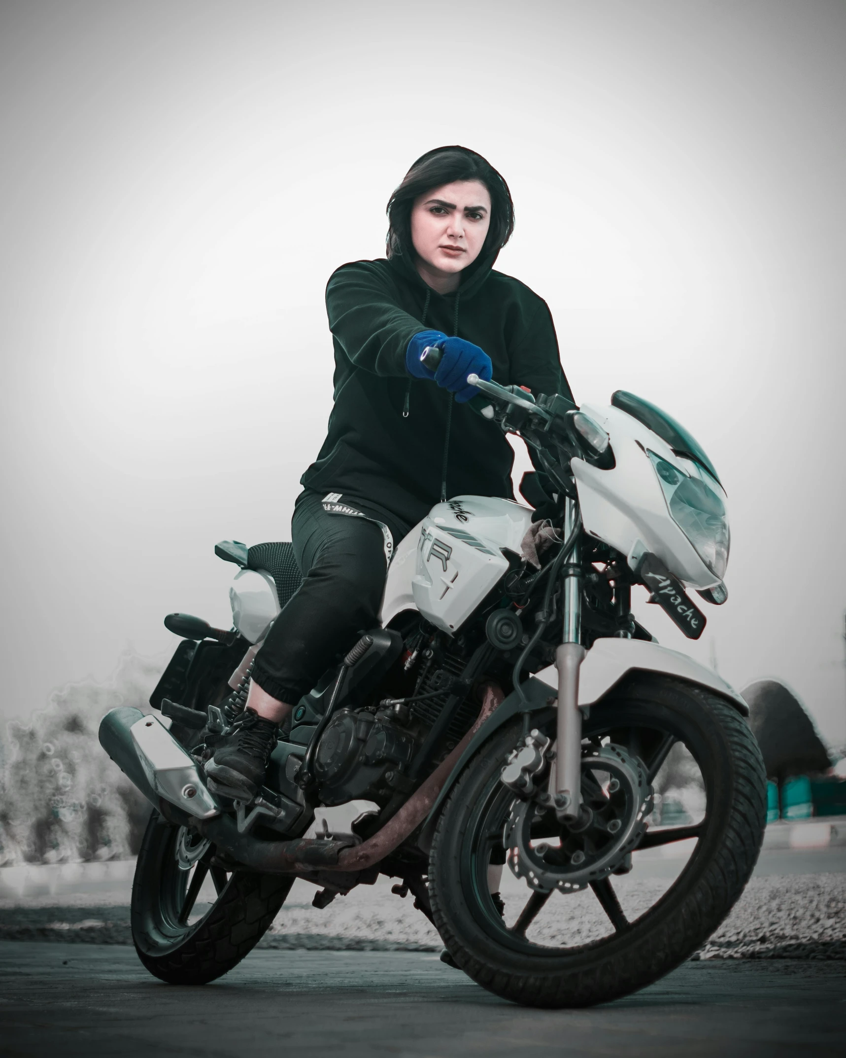 a young man sitting on a parked motorcycle